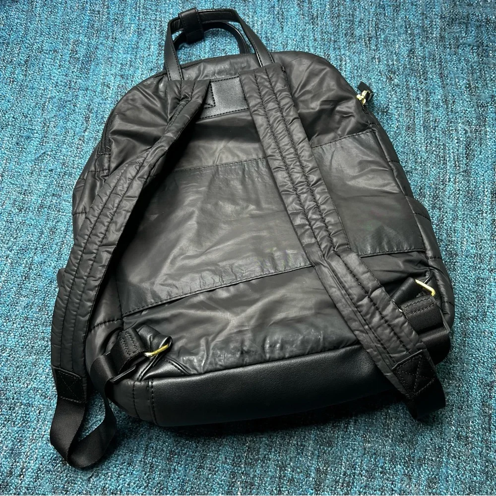 Tutilo Travel Backpack in Black with Gold Quilted Luggage Trolley Sleeve Pocket